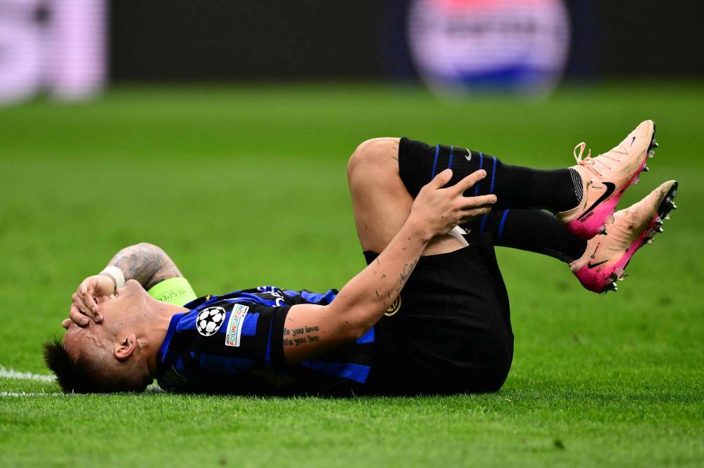 Inter Milan's Argentine forward #10 Lautaro Martinez reacts in pain during the UEFA Champions League semi-final second leg football match between Inter Milan and FC Barcelona at the San Siro stadium in Milan on May 6, 2025. (Photo by Marco BERTORELLO / AFP)