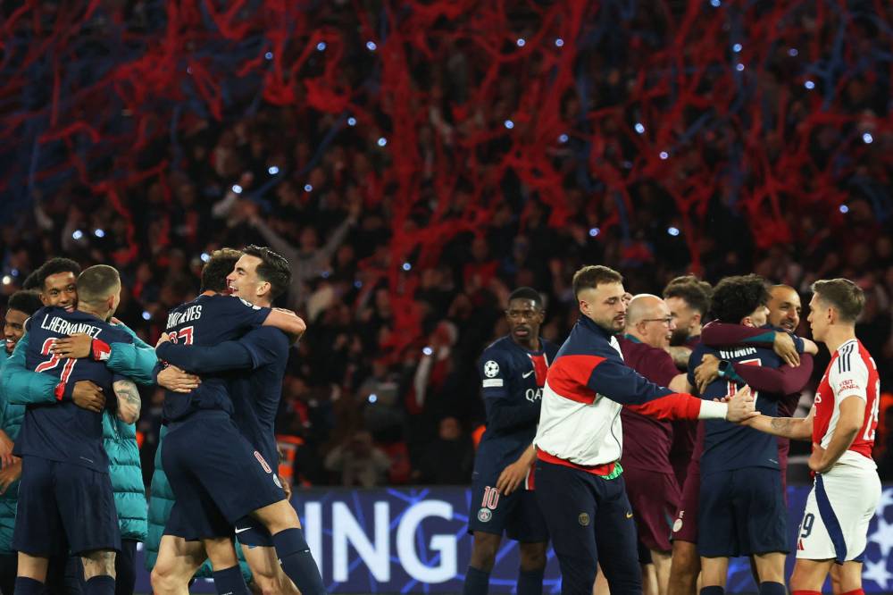Paris Saint-Germain's players celebrate their victory at the end of the UEFA Champions League semi-final second leg football match between Paris Saint-Germain (PSG) and Arsenal at the Parc des Princes stadium in Paris, on May 7, 2025. (Photo by Thomas SAMSON / AFP)