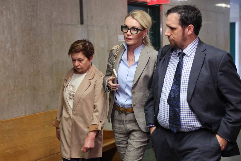 Witness Ewa Sokola (C), sister of Harvey Weinstein's accuser Kaja Sokola, arrives in Manhattan Criminal Court during his rape and sexual assault re-trial in New York on May 7, 2025. (Photo by Spencer Platt / POOL / AFP)