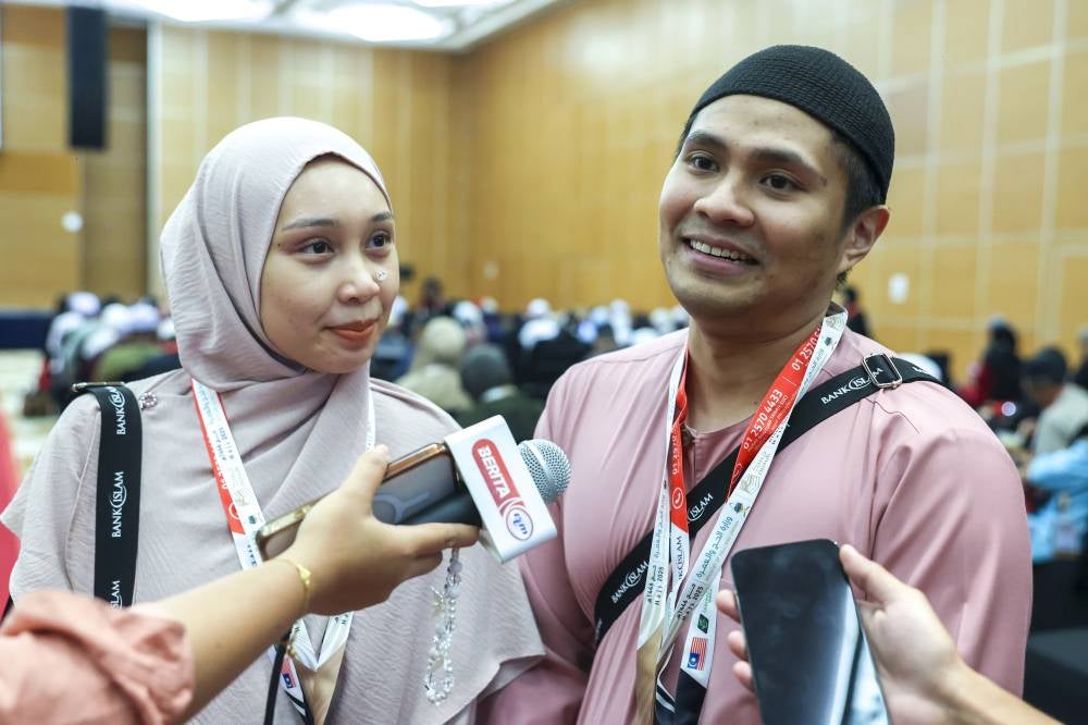 Married couple Muhammad Asyraf Redzuan and Hana Shahira Abdul Halim at the haj pilgrims' departure centre at Movenpick Hotel, Sepang on May 12, 2025. - Photo by Bernama