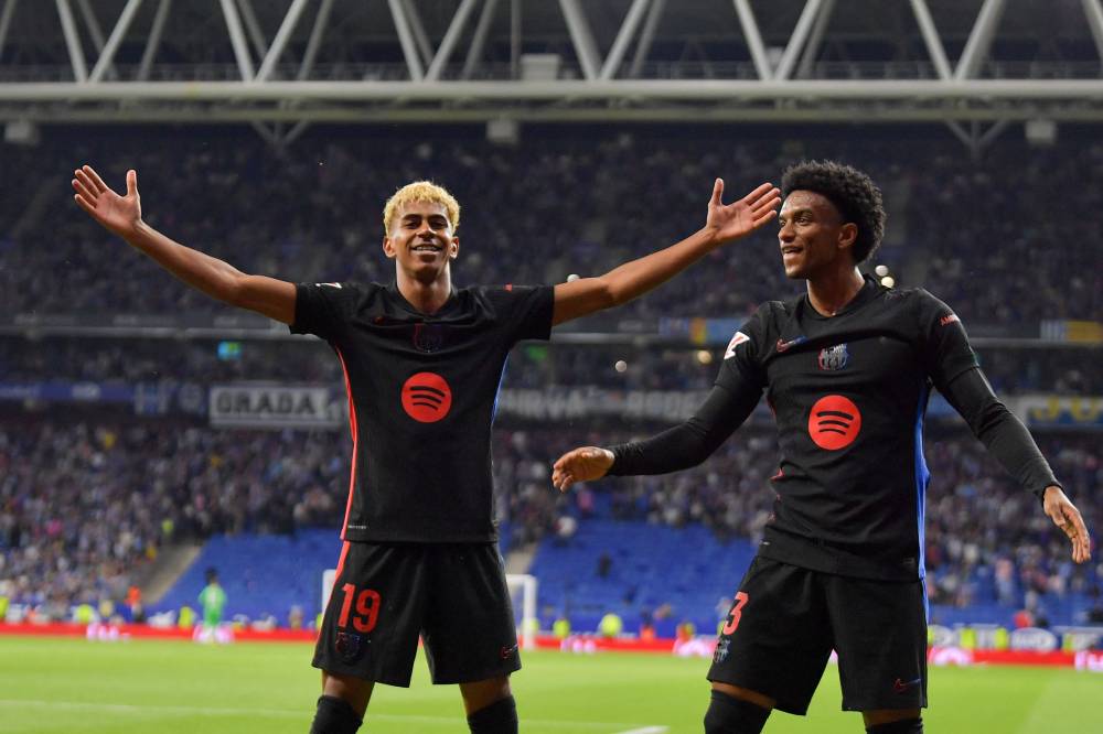Barcelona's Spanish forward #19 Lamine Yamal celebrates scoring his team's first goal next to teammate Barcelona's Spanish defender #03 Alex Balde (R) during the Spanish league football match between RCD Espanyol and FC Barcelona at the RCDE Stadium in Cornella de Llobregat, on May 15, 2025. (Photo by MANAURE QUINTERO / AFP)