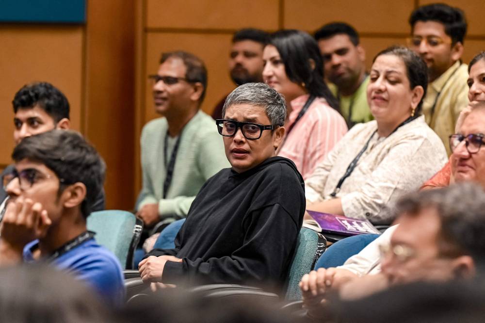 Bollywood film director and screenwriter Reema Kagti (C) attends a masterclass by American screenwriter Alexander Dinelaris and Bollywood actor and filmmaker Boman Irani in Mumbai on November 23, 2024. (Photo by Sujit JAISWAL/AFP)