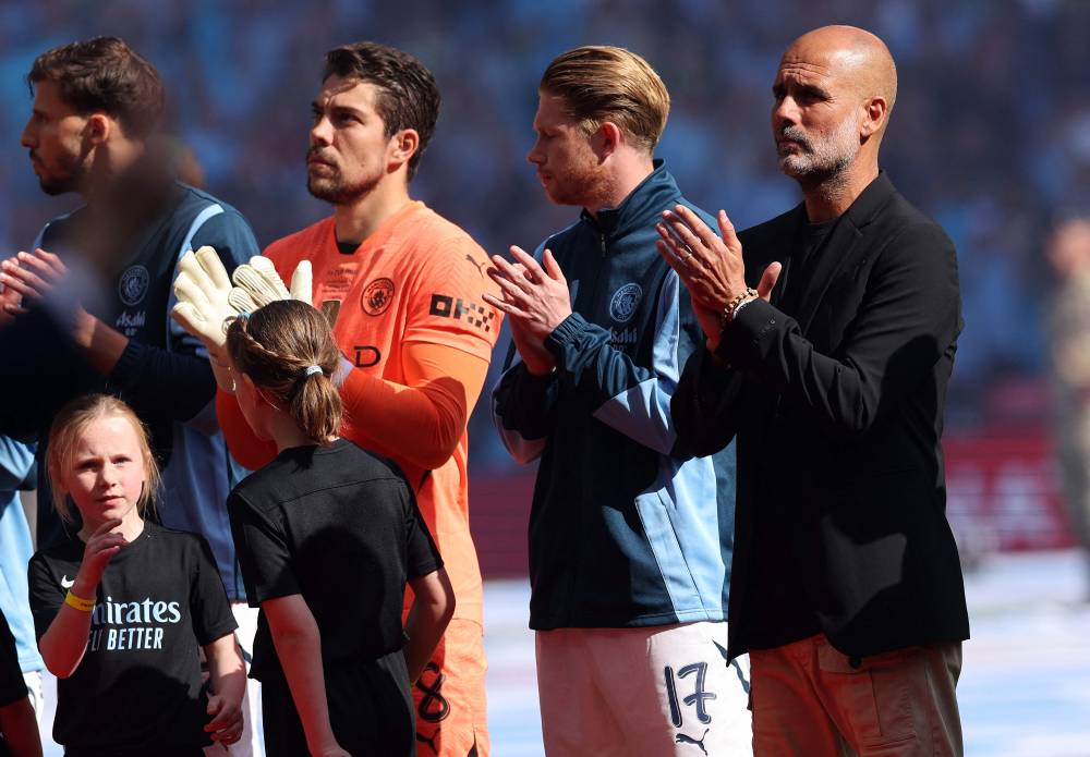 Manchester City's Spanish manager Pep Guardiola applauds the fans ahead of the English FA Cup final football match between Crystal Palace and Manchester City at Wembley stadium in London, on May 17, 2025. (Photo by Adrian Dennis/AFP)
