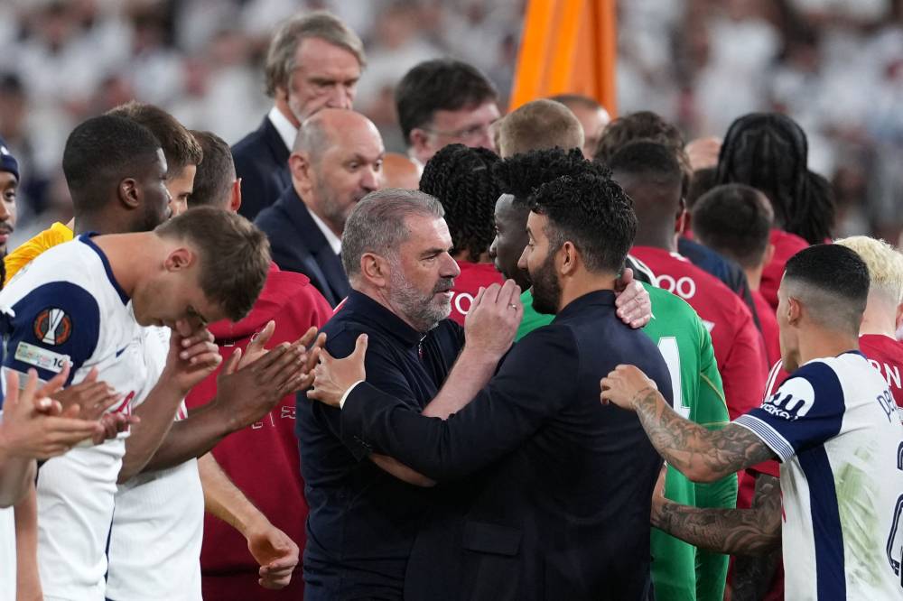 Tottenham Hotspur's Greek-Australian Head Coach Ange Postecoglou (L) and Manchester United's Portuguese head coach Ruben Amorim speak after the UEFA Europa League final football match between Tottenham Hotspur and Manchester United at San Mames stadium in Bilbao on May 21, 2025. (Photo by CESAR MANSO / AFP)