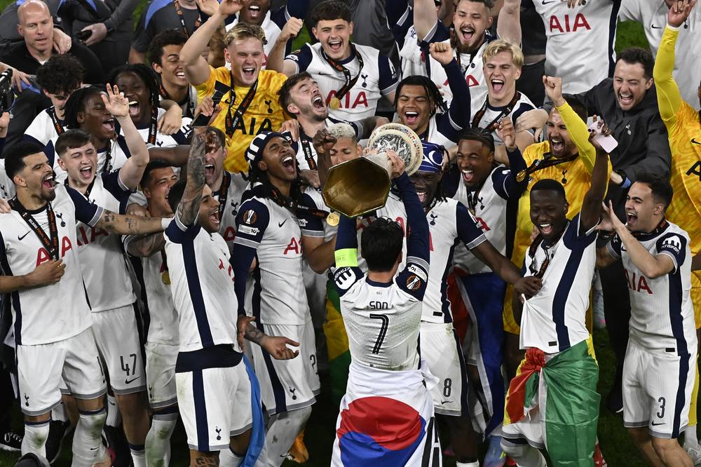 Tottenham Hotspur's players including South Korean forward Son Heung-Min celebrate with the trophy after the UEFA Europa League final football match between Tottenham Hotspur and Manchester United at the San Mames stadium in Bilbao on May 21. (Photo by ANDER GILLENEA / AFP)