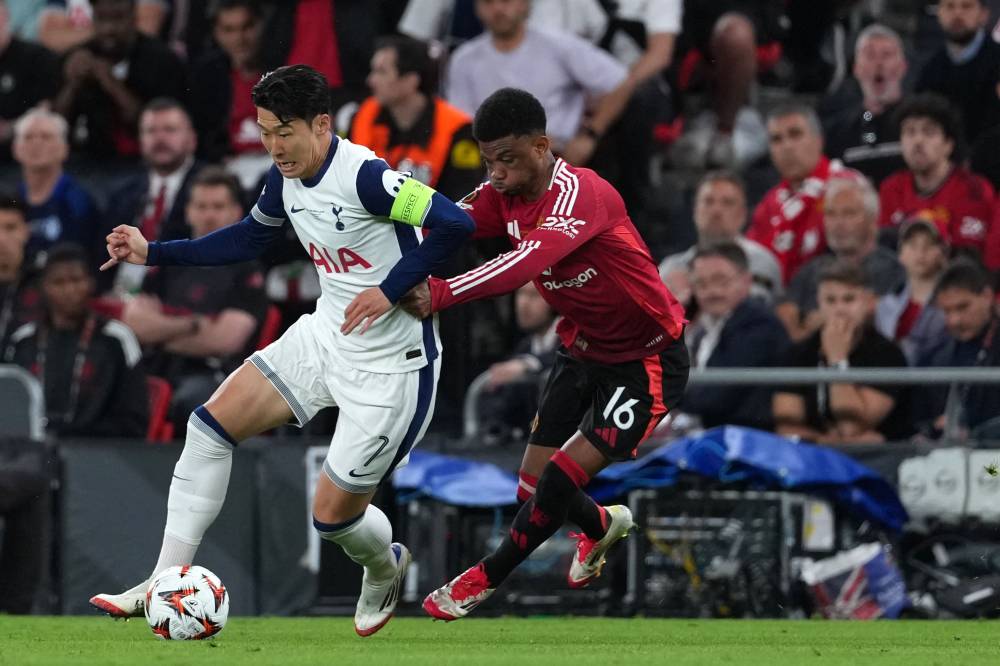 Tottenham Hotspur's South Korean forward Son Heung-min is challenged by Manchester United's Ivorian forward #16 Amad Diallo during the UEFA Europa League final football match between Tottenham Hotspur and Manchester United at San Mames stadium in Bilbao on May 21, 2025. (Photo by CESAR MANSO / AFP)