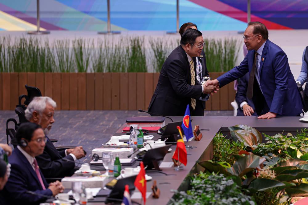 Prime Minister Datuk Seri Anwar Ibrahim (right) shakes hands with the Secretary-General of ASEAN, Dr Kao Kim Hourn, during the plenary session of the 46th ASEAN Summit at the Kuala Lumpur Convention Centre today. - Bernama photo