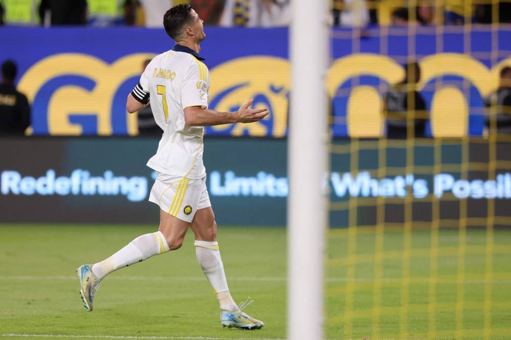 Nassr's Portuguese forward #7 Cristiano Ronaldo celebrates after scoring his team's second goal from the penalty spot during the Saudi Pro League football match between Al-Nassr and Al-Khaleej at Al-Awwal Park in Riyadh on May 21, 2025. (Photo by Fayez NURELDINE/AFP)
