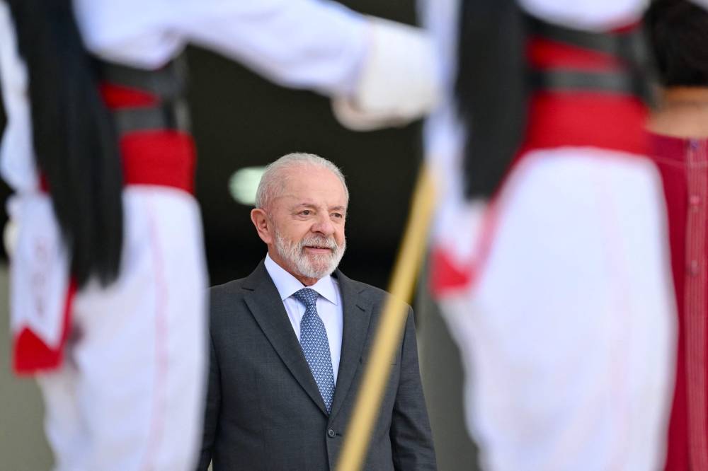 Brazil's President Luiz Inacio Lula da Silva gestures during a military parade welcoming Angola's President Joao Lourenco at Planalto Palace in Brasilia, on May 23, 2025. (Photo by EVARISTO SA / AFP)