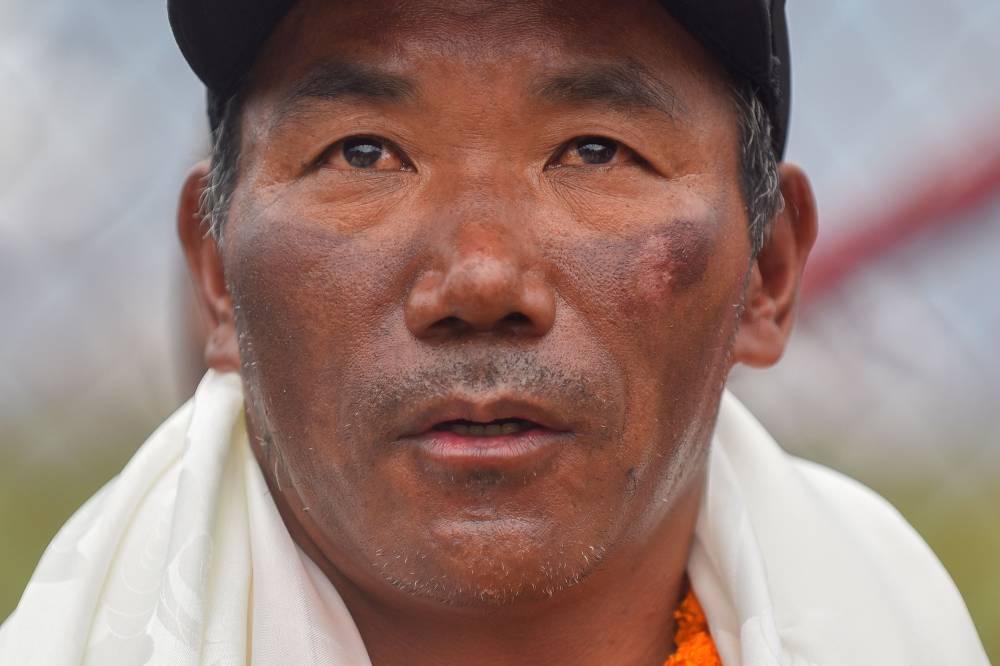 Nepali guide Kami Rita Sherpa who reached the top of Mount Everest on May 23, 2023, for a record 28th time looks on after his arrival at the Tribhuvan airport in Kathmandu on May 25, 2023. (Photo by NISHA BHANDARI / AFP)