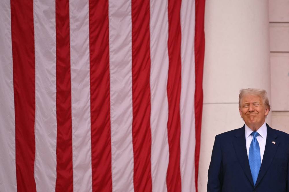 US President Donald Trump smiles before speaking in the amphitheatre at the Tomb of the Unknown Soldier in Arlington National Cemetery in Arlington, Virginia, on Memorial Day, May 26, 2025. (Photo by SAUL LOEB/AFP)