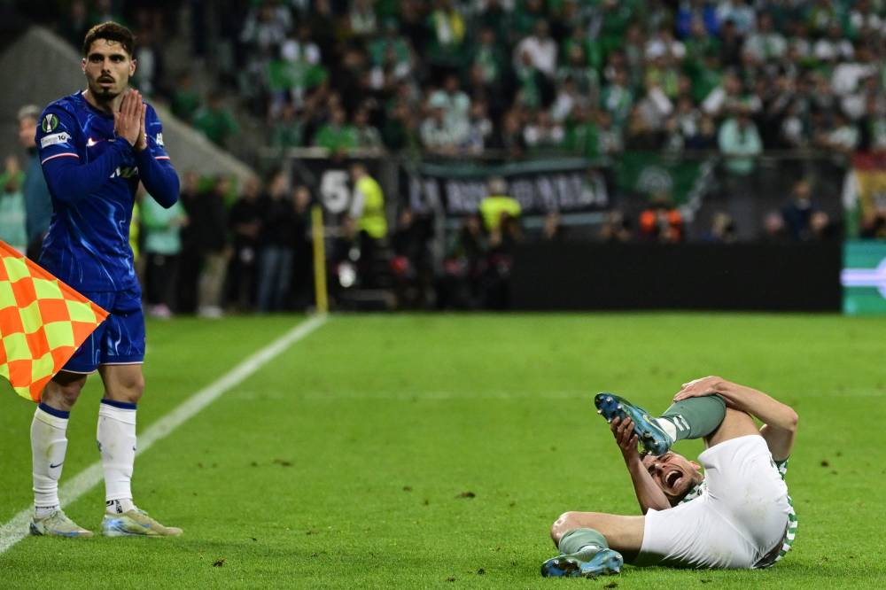 Real Betis' French defender #15 Romain Perraud lies on the ground after being fouled by Chelsea's Portuguese midfielder #07 Pedro Neto during the UEFA Conference League final football match between Real Betis and Chelsea FC in Wroclaw on May 28, 2025. (Photo by John MACDOUGALL / AFP)