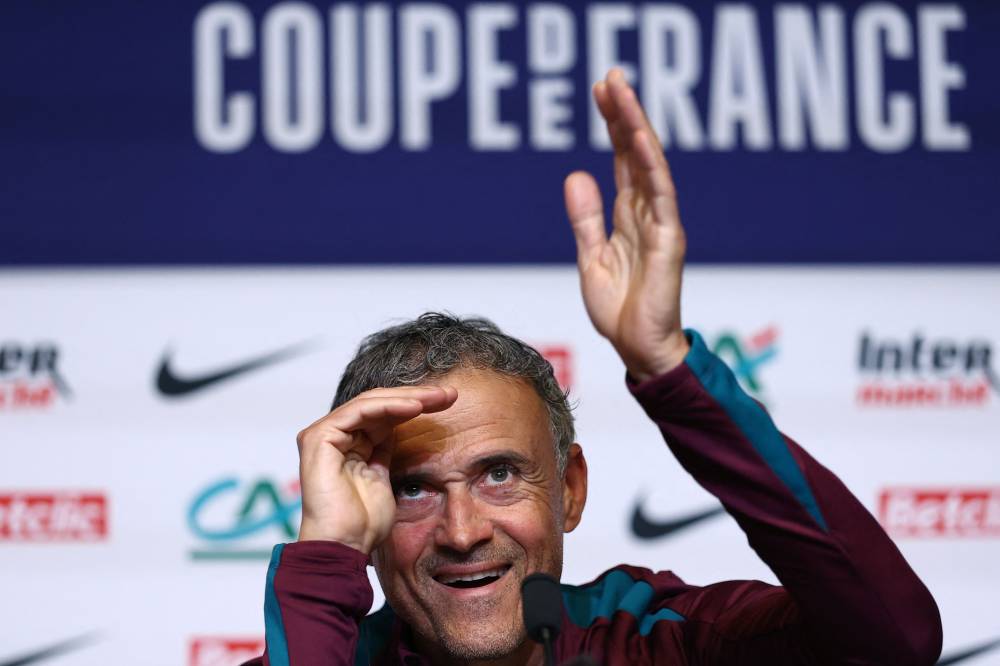 Paris Saint-Germain's Spanish head coach Luis Enrique waves during a press conference in Poissy, west of Paris, on May 23, 2025, the day before the French Cup final football match against Stade de Reims. PSG will play the French Cup final football match against Stade de Reims on May 24, 2025 and Champions League's against Inter Milan on May 31, 2025. (Photo by FRANCK FIFE / AFP)