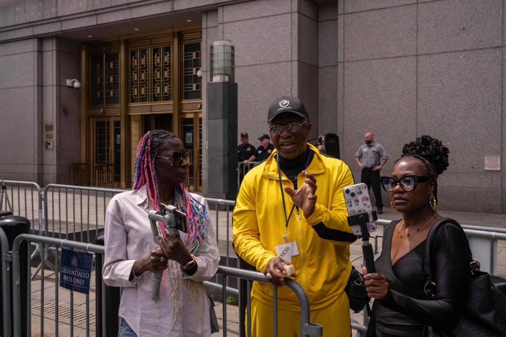 People film for social media with their phones outside of the Sean "Diddy" Combs sex trafficking trial at Manhattan Federal Court on May 27, 2025 in New York City. (Photo by Adam Gray / GETTY IMAGES NORTH AMERICA / Getty Images via AFP)