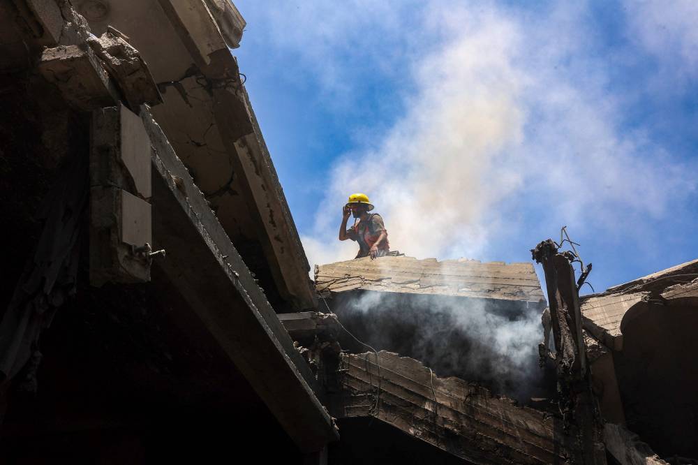 A rescuer stands on the rubble of the al-Bursh family home, after it was targeted in an Israeli strike in Jabalia in the northern Gaza Strip on June 2, 2025. (Photo by Omar AL-QATTAA / AFP)