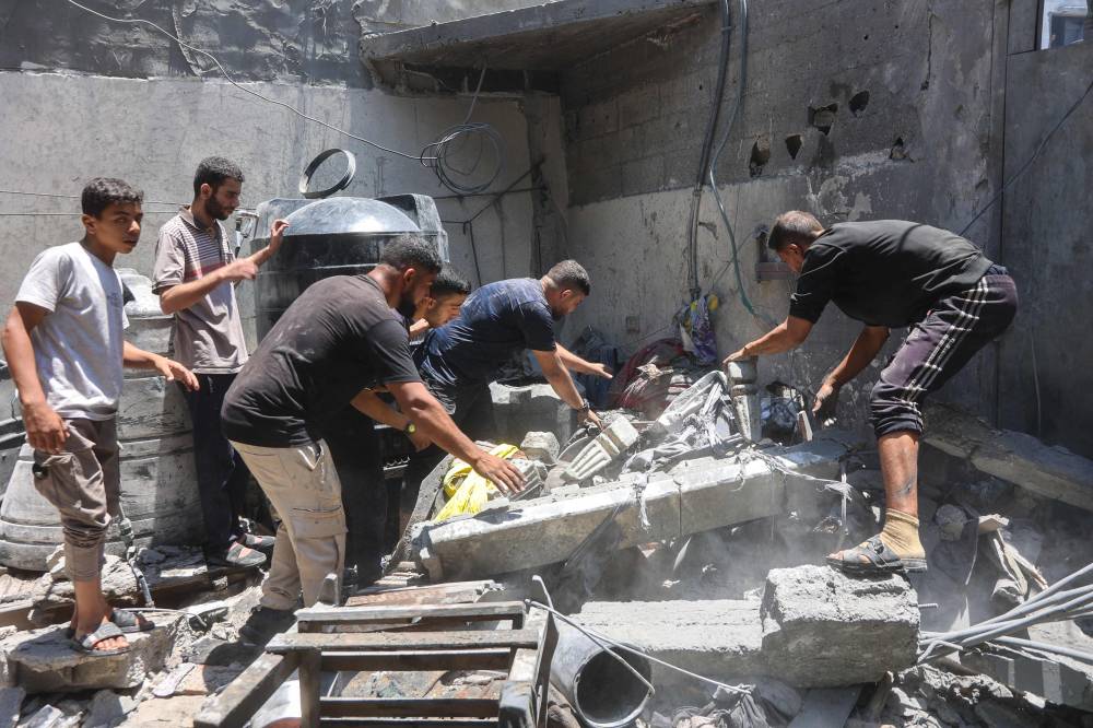 People look for survivors following an Israeli strike that targeted the home of the al-Bursh family in Jabalia in the northern Gaza Strip on June 2, 2025. (Photo by Omar AL-QATTAA / AFP)