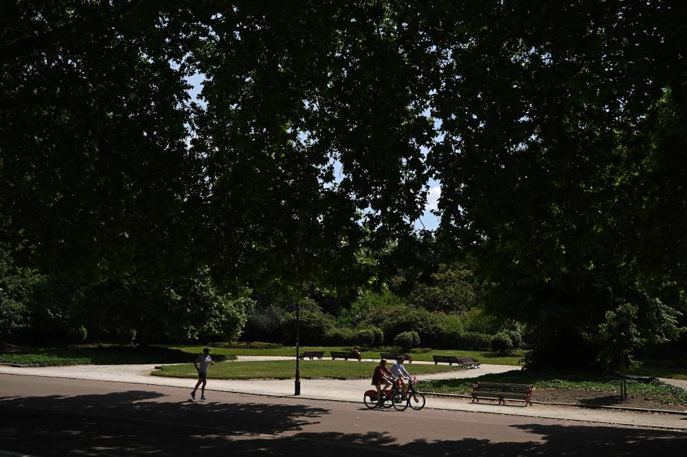 People enjoy the sunshine in Battersea Park, south west London on May 31, 2025. (Photo by JUSTIN TALLIS / AFP)