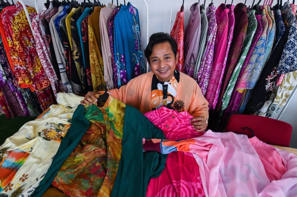 Wan Zakaria Wan Abu Bakar, 43, the founder of Bizara Educare Centre and a passionate batik enthusiast, showcased his personal collection of batik shirts during an interview with reporters at Kampung Panji recently. Photo by Bernama