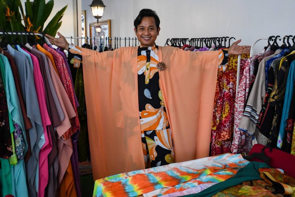Wan Zakaria Wan Abu Bakar, 43, the founder of Bizara Educare Centre and a passionate batik enthusiast, showcased his personal collection of batik shirts during an interview with reporters at Kampung Panji recently. Photo by Bernama