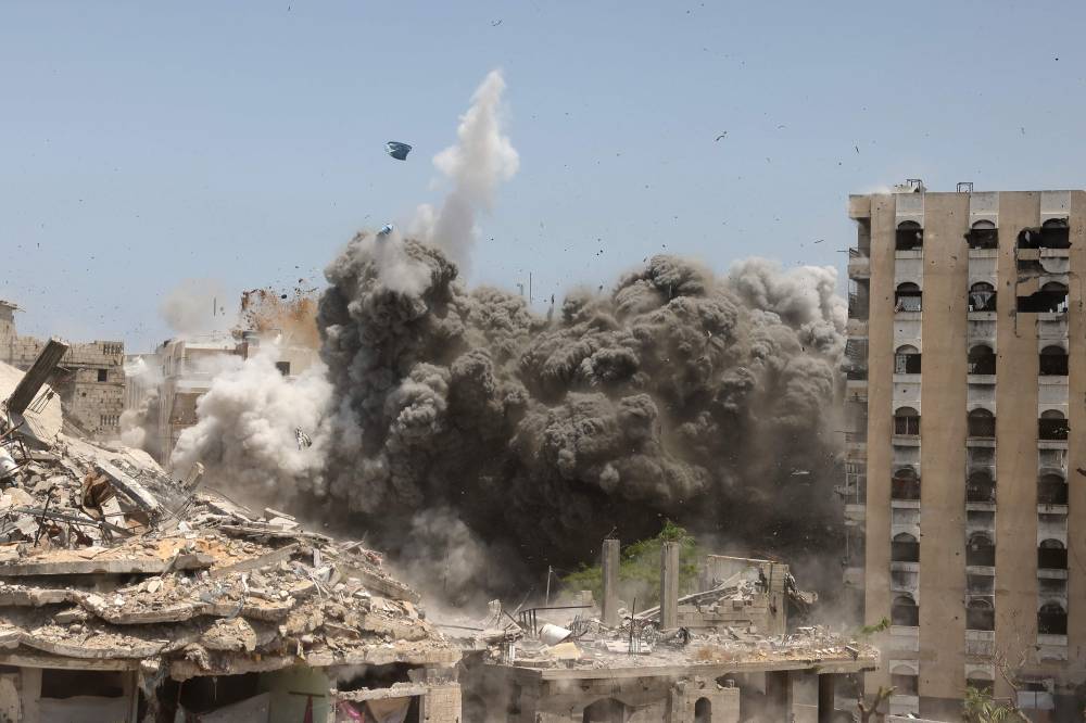 Smoke and debris rise following an Israeli strike on a house west of Jabalia, in the northern Gaza Strip, on June 1, 2025, amid the war between Israel and the Palestinian Hamas militant movement. - (Photo by BASHAR TALEB / AFP)