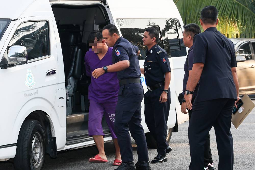 The man who slashed his wife to death in Bukit Gambir last Monday has been remanded for seven days from today to facilitate further investigations. - Photo by Bernama