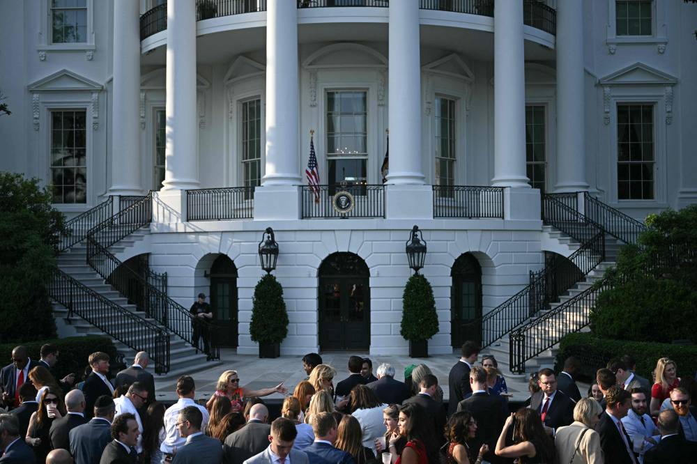 People attend a Summer Soiree with unseen US President Donald Trump on the South Lawn of the White House in Washington, DC, on June 4, 2025. (Photo by Brendan SMIALOWSKI / AFP)