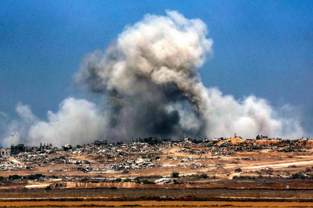A plume of smoke erupts during Israeli bombardment in the Gaza Strip on June 5, 2025. - (Photo by JACK GUEZ / AFP)