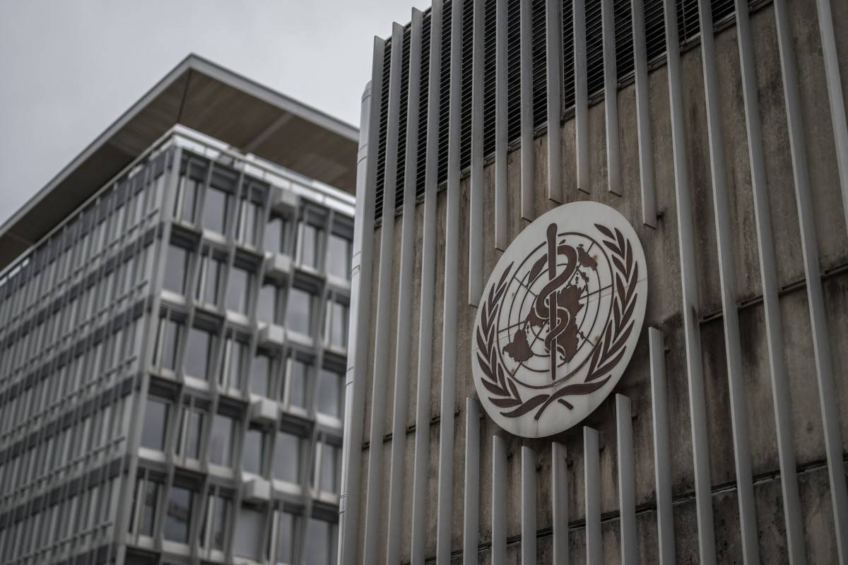 This photograph shows a logo of the World Health Organisation displayed on the facade of organisation's headquarters in Geneva on April 23, 2025. - (Photo by FABRICE COFFRINI / AFP)