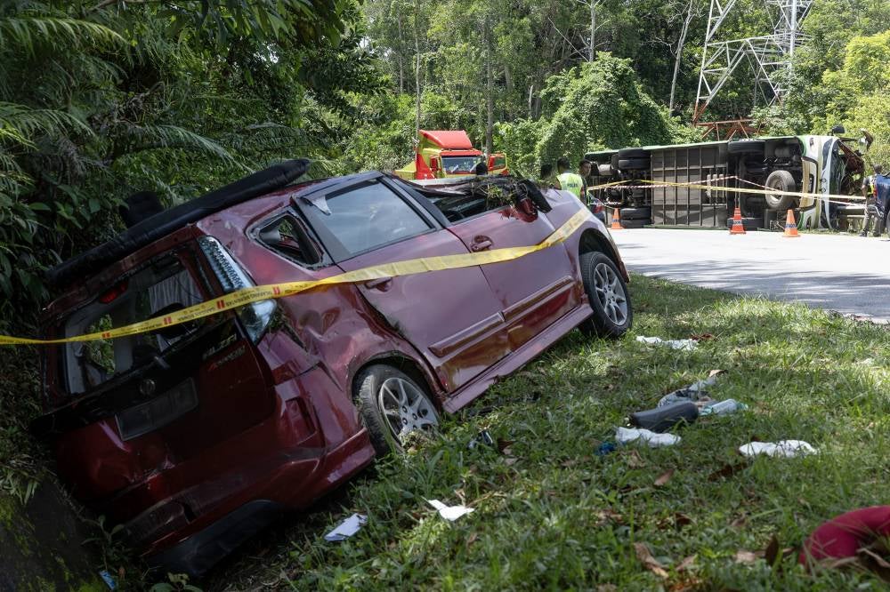 The bus was reported to have overturned, while the Perodua Alza skidded into a ditch. Photo by Bernama