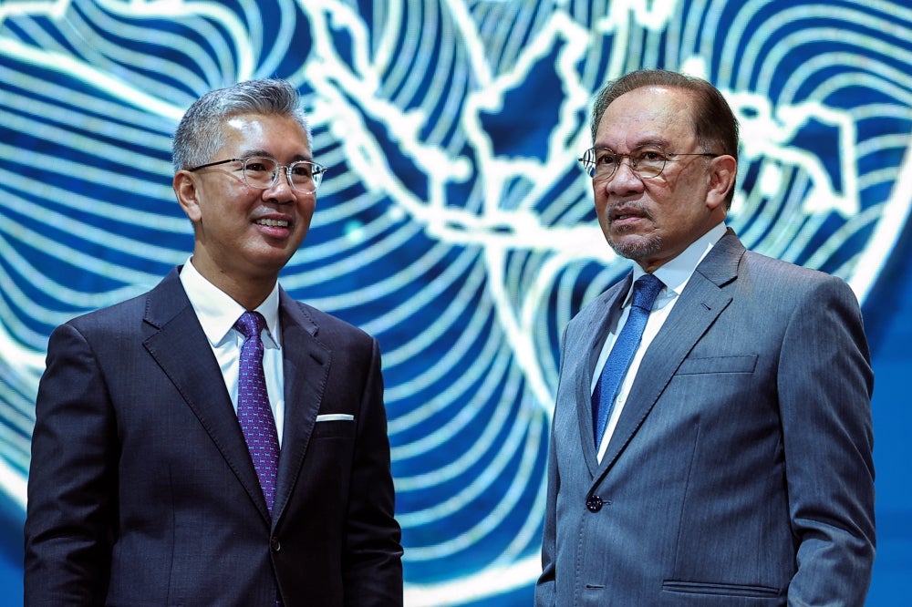 Tenku Zafrul (left) and Anwar Ibrahim (right). - Photo by Bernama 