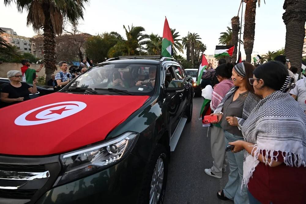 Tunisians gather at a meeting point in Tunisian capital Tunis ahead of the departure of a land convoy aiming to break Israel's siege on Gaza, on 9 June. Photo by Fathi Belaid/AFP