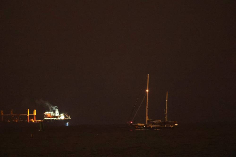 A picture shows the aid sailboat Madleen approaching the southern port of Ashdod after being intercepted by Israeli forces on June 9, 2025. - (Photo by JACK GUEZ / AFP)