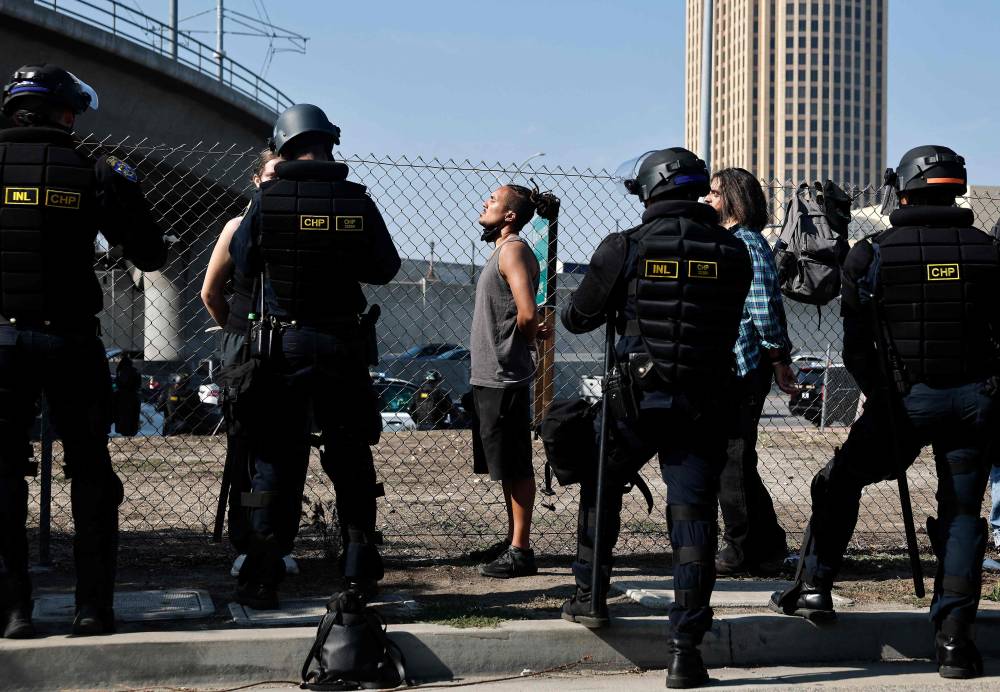 California Highway Patrol officers detain protesters near the 101 freeway on June 10, 2025 in Los Angeles, California. - (Photo by MARIO TAMA / AFP)