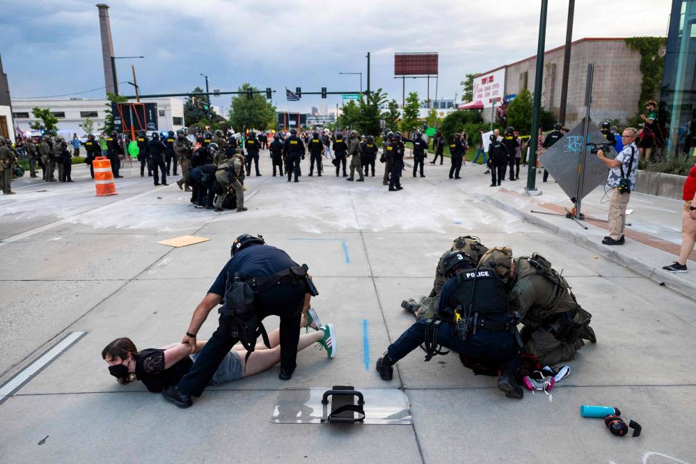 Police arrest protesters during a march against Immigration and Customs Enforcement (ICE) on June 10, 2025 in Denver, Colorado. - (Photo by Michael Ciaglo / AFP)