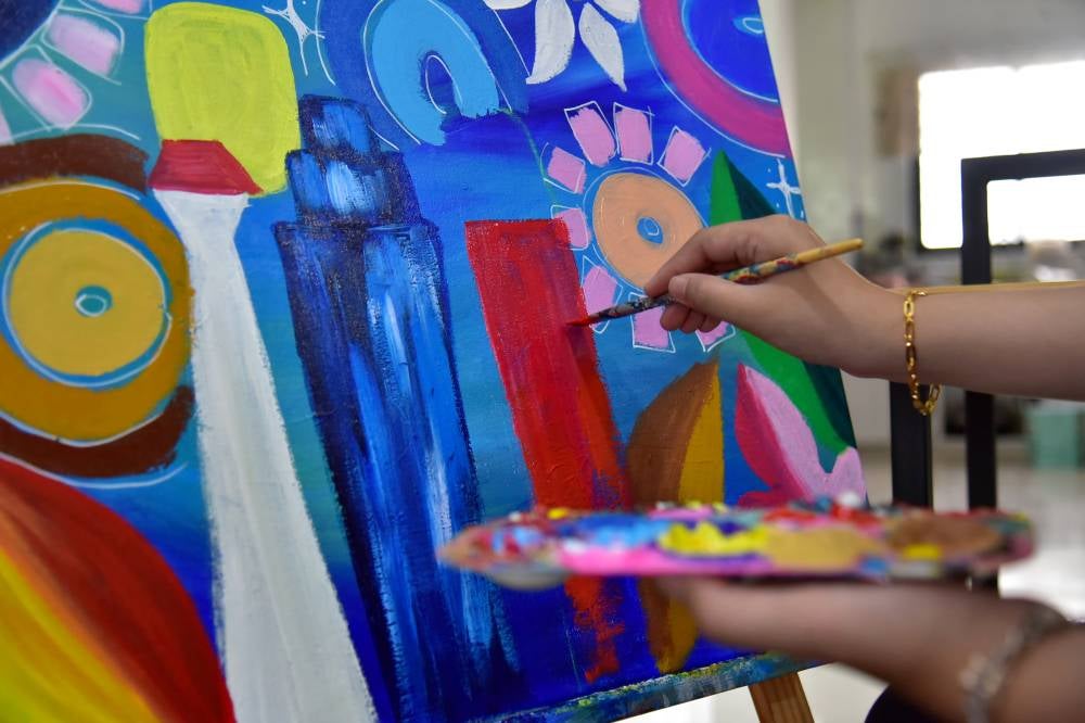 At just 17, Danya Adriana Feri Pito Manda is making a name for herself in Malaysia’s local art scene as a young painter who infuses abstract art with the richness of Malay culture - offering a refreshing blend of tradition and contemporary style. Photo by Bernama