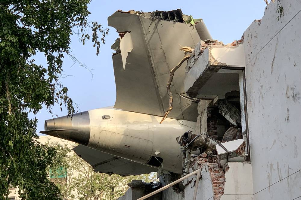 The back of Air India flight 171 is pictured at the site after it crashed in a residential area near the airport in Ahmedabad on June 12, 2025. - (Photo by SAM PANTHAKY / AFP)