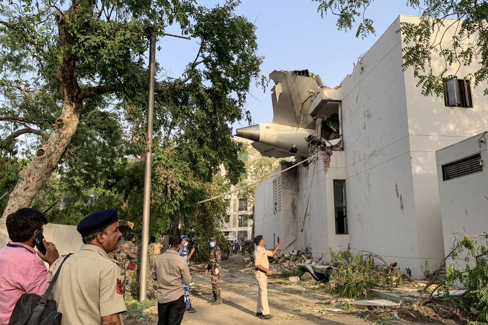 The back of Air India flight 171 is pictured at the site after it crashed in a residential area near the airport in Ahmedabad on June 12, 2025. - (Photo by SAM PANTHAKY / AFP)