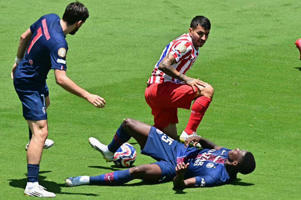 Paris Saint-Germain's Portuguese defender #25 Nuno Mendes (down) is fouled by Atletico Madrid's Argentine forward #10 Angel Correa during the Club World Cup 2025 Group B football match between France's Paris Saint-Germain and Spain's Atletico de Madrid at the Rose Bowl stadium in Los Angeles on June 15, 2025. (Photo by Frederic J. Brown / AFP)