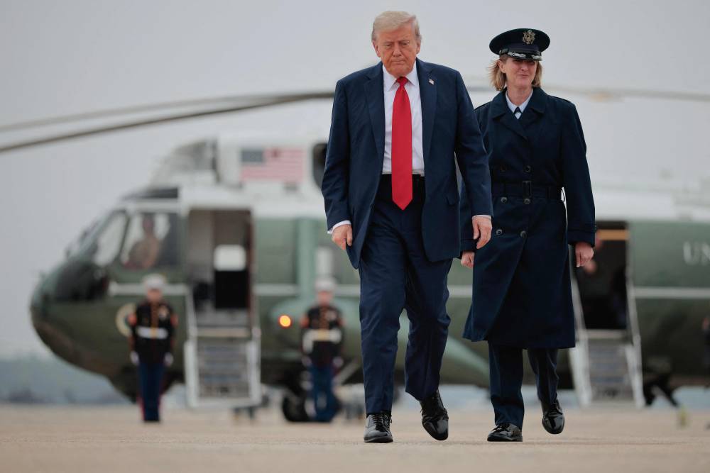 Donald Trump walks across the tarmac before boarding Air Force One and traveling to the G7 leaders' summit in Canada on June 15, 2025 at Joint Base Andrews, Maryland. - AFP photo