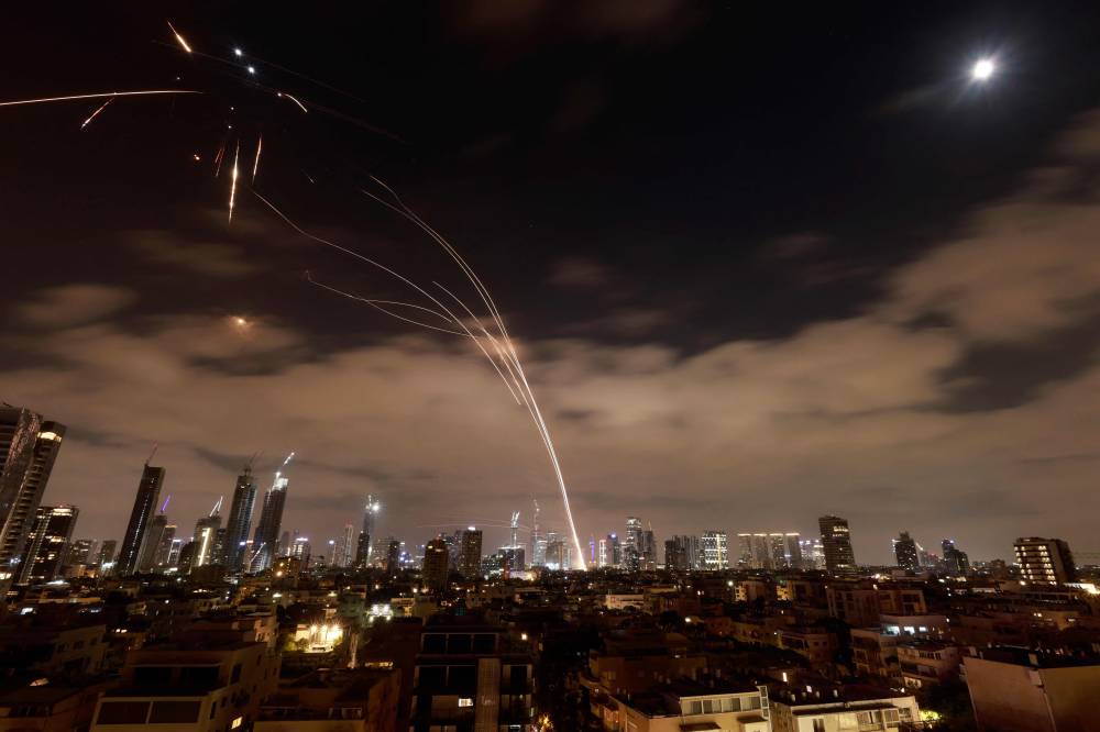 Israeli air defence systems are activated to intercept Iranian missiles over the Israeli city of Tel Aviv amid a fresh barrage of Iranian rockets on June 16, 2025. - (Photo by Menahem Kahana / AFP)