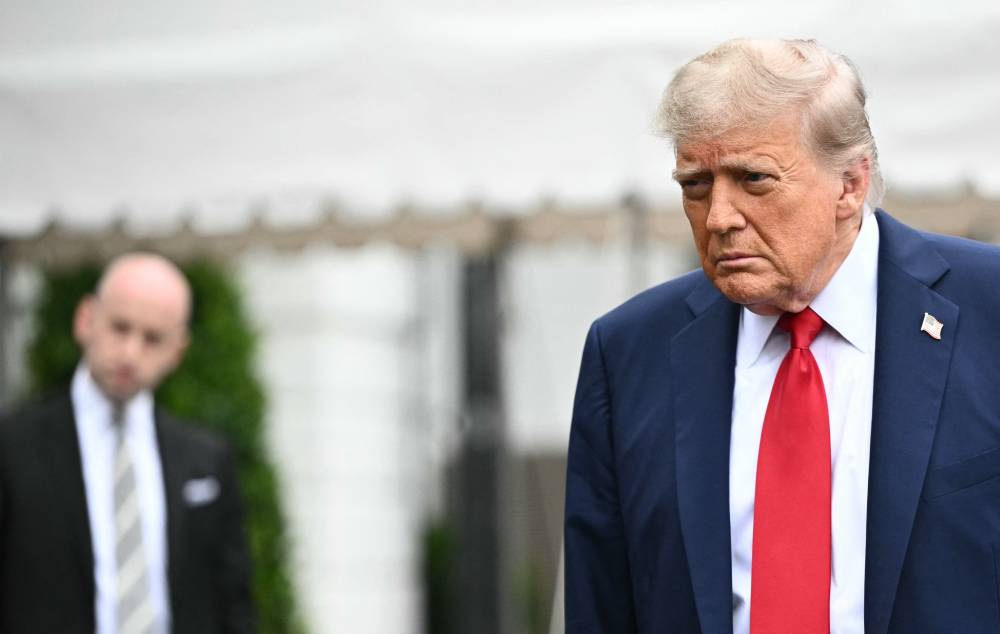 White House Deputy Chief of Staff for Policy and Homeland Security Advisor Stephen Miller watches US President Donald Trump speak to journalists as he makes his way to board Marine One before departing from the South Lawn of the White House in Washington, DC on June 15, 2025. Trump is headed to Canada to attend the G7 summit. (Photo by Mandel NGAN / AFP)