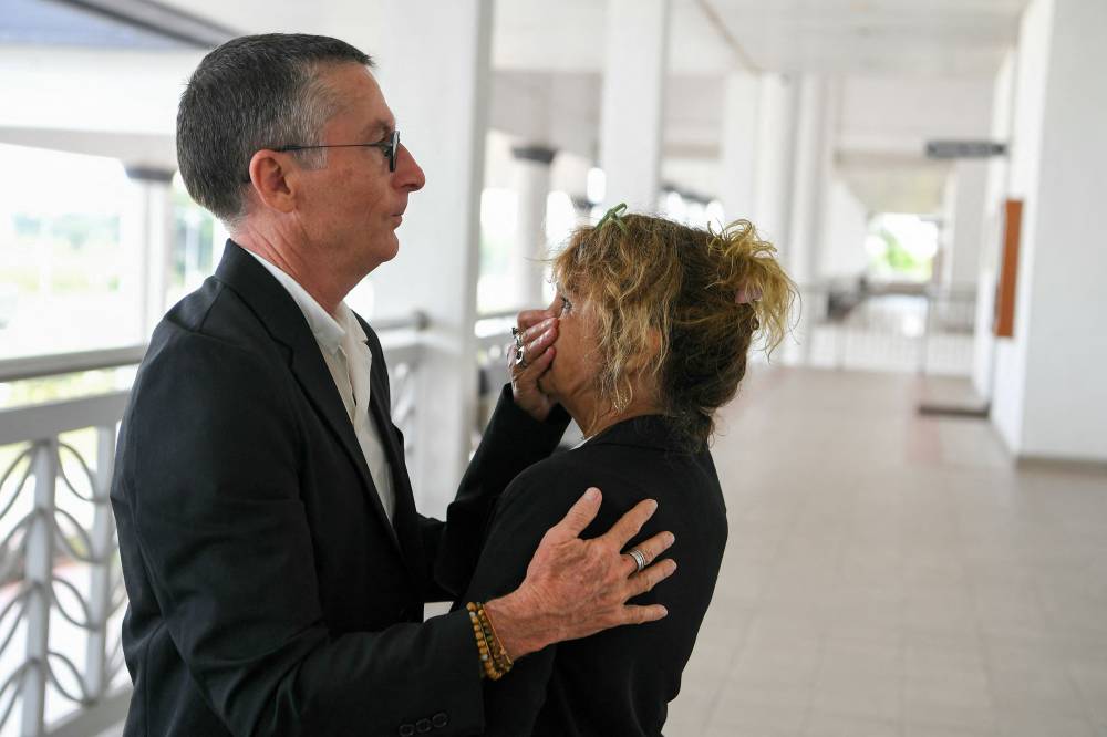 Jean Luc Felix (L) and Sylvie Felix (R), the parents of French national Tom Felix who is accused of cannabis possession and trafficking in Malaysia, react at the High Court in Alor Setar on June 16, 2025. - (Photo by Hakim Mustapha / AFP)
