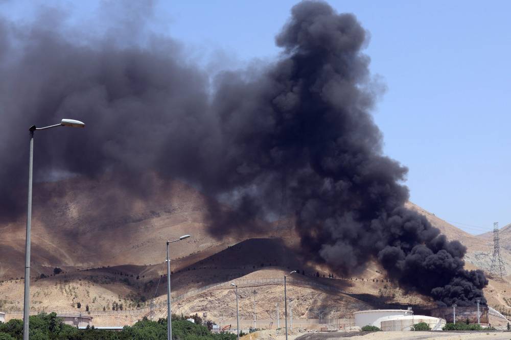 Smoke billows for the second day from the Shahran oil depot, northwest of Tehran, on June 16, 2025. Photo by AFP