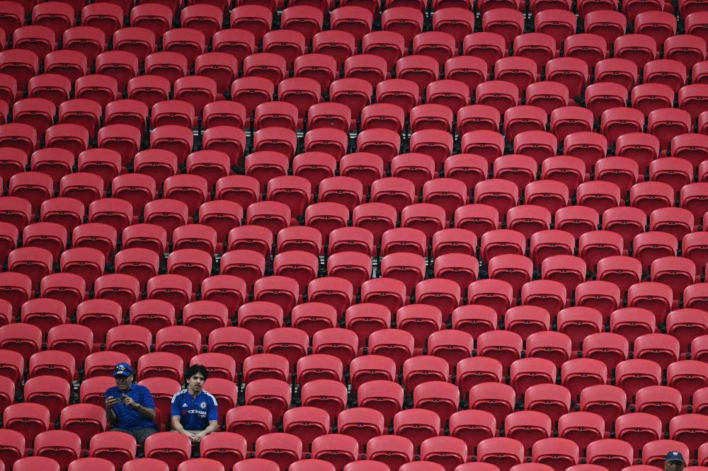 Two Chelsea's supporters sit in an empty tribune during the Club World Cup 2025 Group D football match between England's Chelsea and US Los Angeles FC at the Mercedes-Benz stadium in Atlanta. Photo by Paul Ellis/AFP