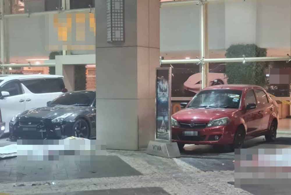 Scene at the location where two men were shot dead in front of the shopping mall in Cheras, here, on Tuesday.