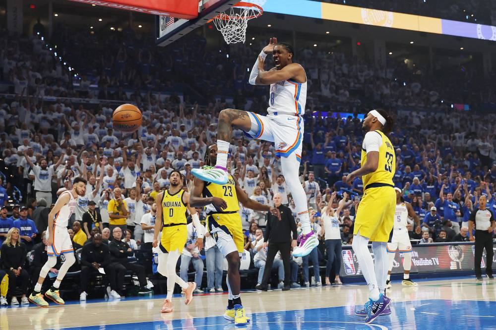 Jalen Williams #8 of the Oklahoma City Thunder dunks the ball against Aaron Nesmith #23 and Myles Turner #33 of the Indiana Pacers during the first quarter in Game Five of the 2025 NBA Finals at Paycom Centre. Photo by AFP