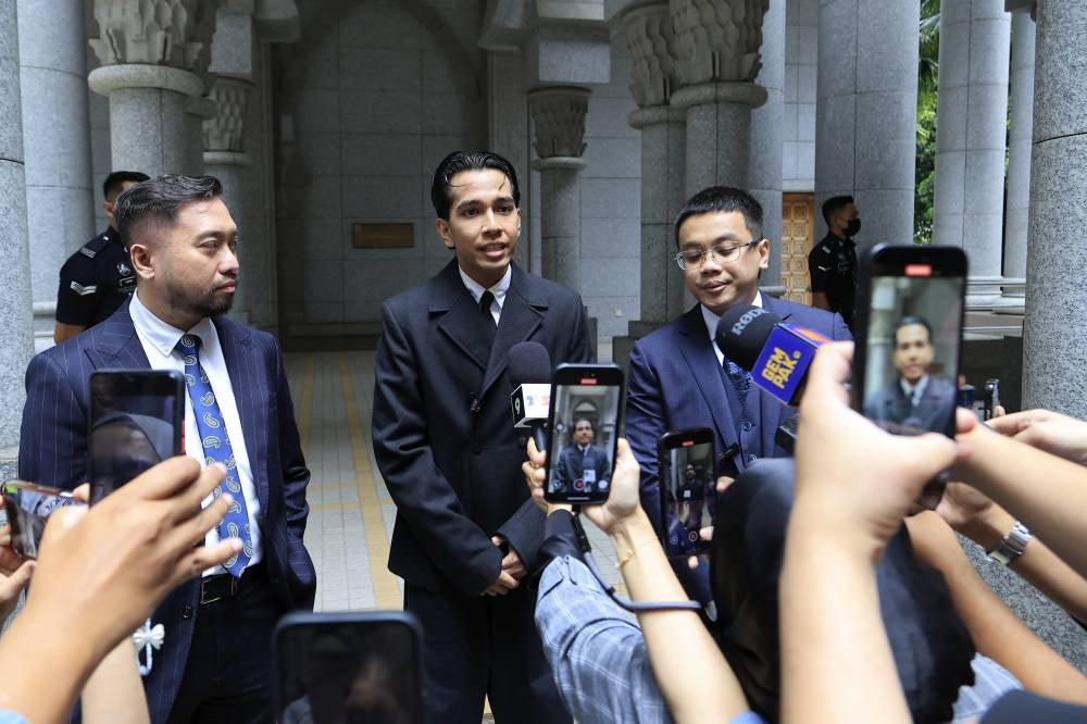 Singer Naim Daniel (middle) pleaded not guilty at the Sessions Court today to a charge of committing sexual assault against a 17-year-old girl at a hotel in May. - Photo by Bernama