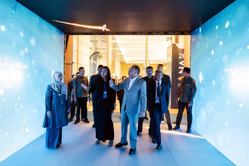 Prime Minister Datuk Seri Anwar Ibrahim visiting the exhibition area at the Sasana Symposium 2025, today. Also present, Bank Negara Governor Datuk Seri Abdul Rasheed Ghaffour. - Photo by Bernama