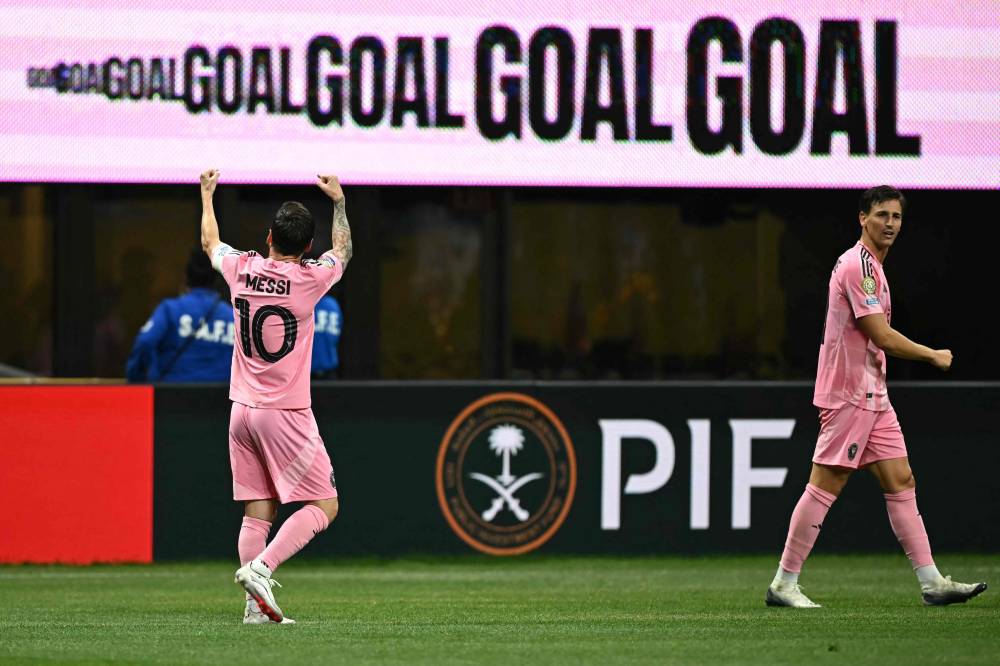 Inter Miami's Argentine forward #10 Lionel Messi (L) celebrates after scoring his team's second goal during the FIFA Club World Cup 2025 Group A football match between US Inter Miami and Portugal's FC Porto at the Mercedes-Benz stadium in Atlanta on June 19, 2025. (Photo by Paul ELLIS / AFP)