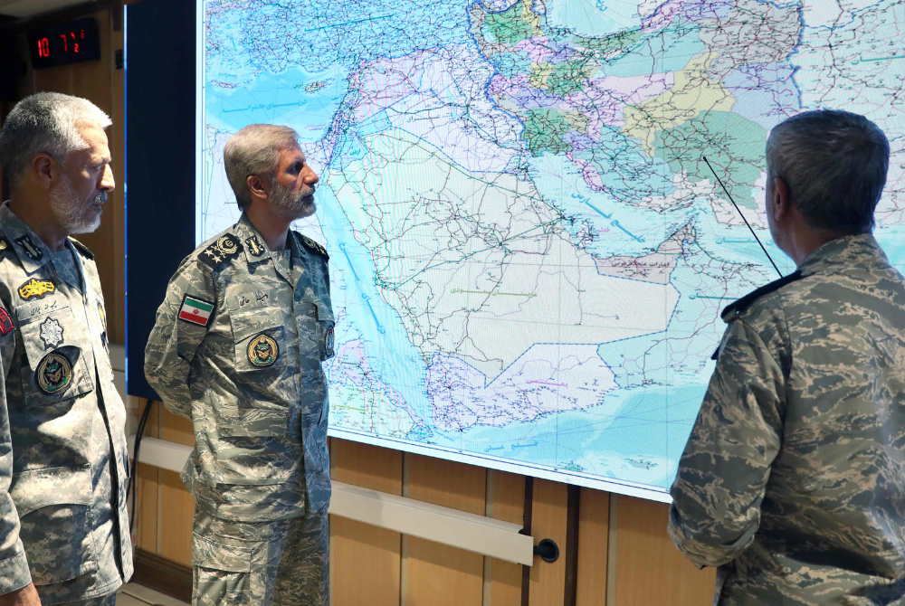 This handout picture provided by the Iranian Army media office on June 23, 2025, shows the Army commander-in-chief Amir Hatami (C) attending a meeting in the Iranian Army's War Command Room. (Photo by Iranian Army Media Office / AFP)